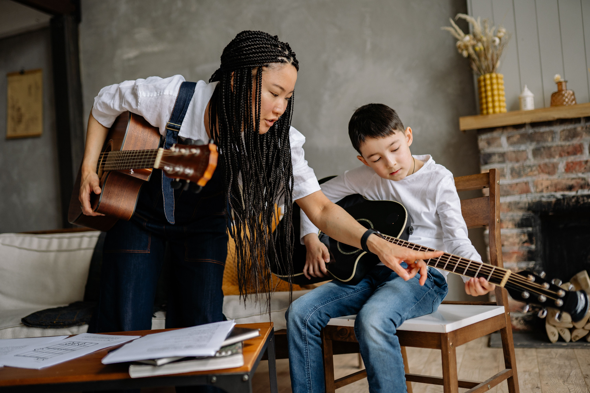 Guitar teacher guiding a young student through a chord during a private lesson near Daytona Beach